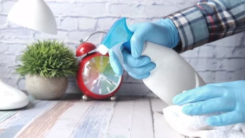 Hands Cleaning Surface with Spray and Cloth
