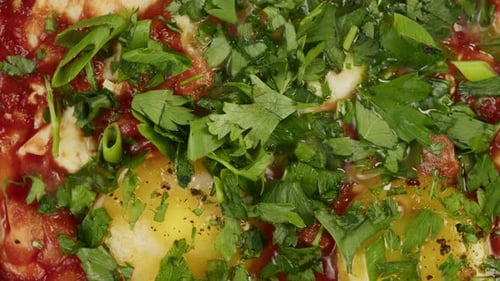 Close-Up of Colorful Shakshuka Dish with Fresh Herbs
