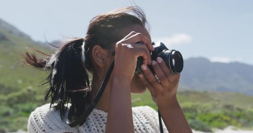 Woman Photographing Nature with Vintage Camera