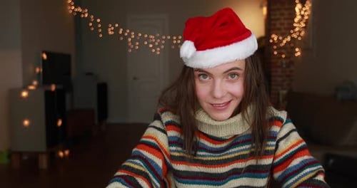 Smiling Woman with Santa Hat at Christmas