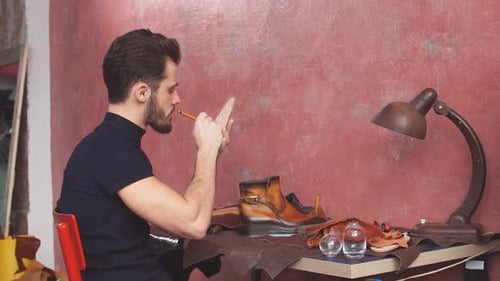Man Crafting Leather Shoes in Workshop