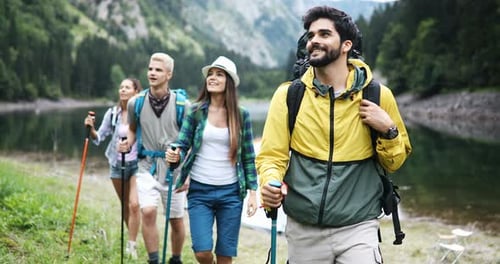 Group Hiking Together Near Mountain Lake