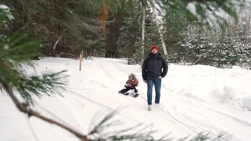 Father and Son in Winter Snow Forest Walking