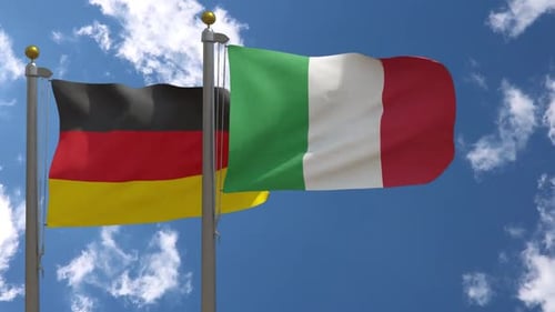 German and Italian Flags Waving in Blue Sky