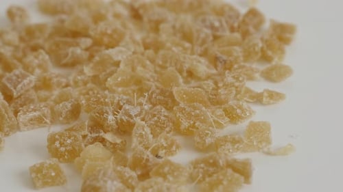 Pieces of candied ginger root on the table slow tilt 4K 2160p 30fps UltraHD footage - Crystallized Z