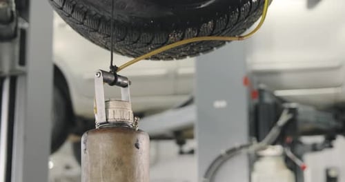 Close up Dirty Container and Tire in Workshop