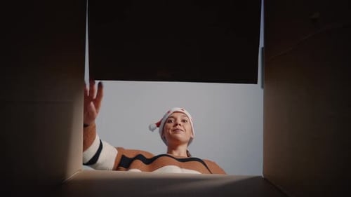 Woman Excitedly Opens Christmas Gift