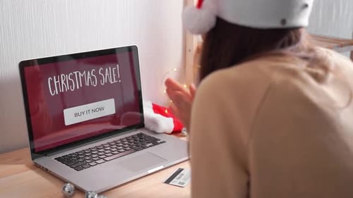 Young Woman Buying Online Gifts for Christmas with Credit Card. Online Xmas Shopping. Black Friday