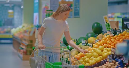 Woman Shops for Lemons at Grocery Store