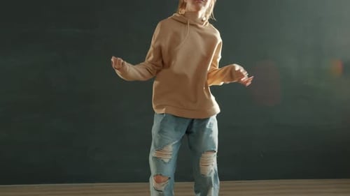 Slow Motion Portrait of Pretty Blonde with Ponytail Practicing Modern Dance in Dark Studio