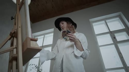 Young Woman Painting Art in Studio