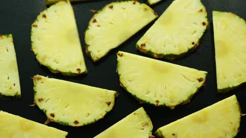Sliced Pineapple Close Up on Dark Surface