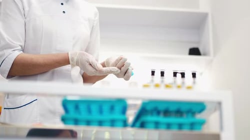 Medical Professional Examining Test Tubes of Blood
