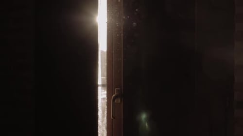 Sunlight Shining Through Window Shutters at Sunrise