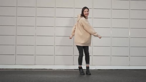 Joyful Woman Dancing in Urban Fashion Style