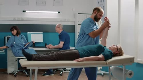 Physical Therapist Assisting Senior Woman with Exercises