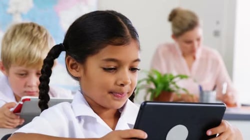 School kids using digital tablet in classroom