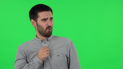 Man Fanning Himself on Green Screen, Overheated