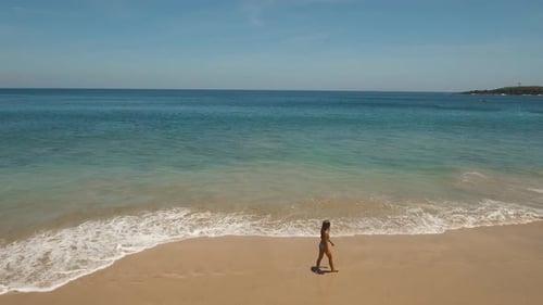 Girl Walking on the Beach