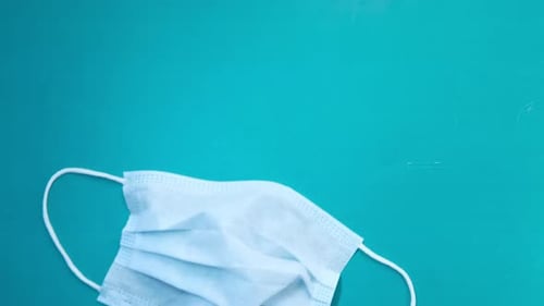 Doctor Hand in Medical Glove Holding Protective Surgical Face Mask, Close Up