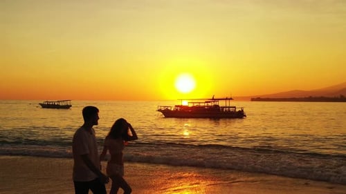 Romantic boy and girl on romantic honeymoon have fun on beach on sunny white sandy background 4K
