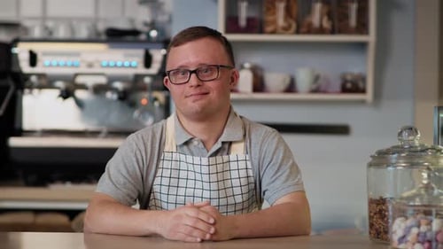 Portrait of caucasian man with down syndrome working in the cafe. Shot with RED helium camera in 8K.