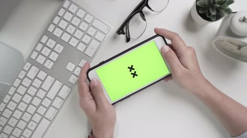 Businesswoman 's hands working and touch screen the green screen on smartphone