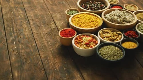 Various Spices and Herbs in Bowls on Table