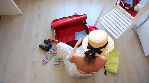 Woman Packing Suitcase for Vacation Travel