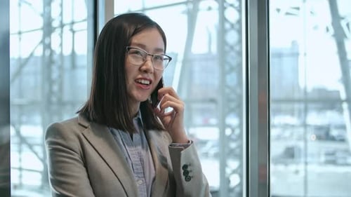 Woman Talking on Phone in Modern Office Building