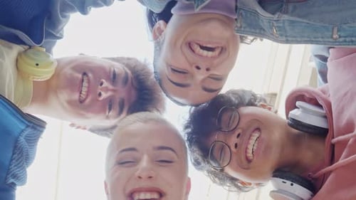 Group of Young Multiethnic Students Standing in a Circle Having Fun