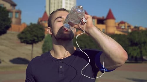 Young Man Drinking Water After Workout