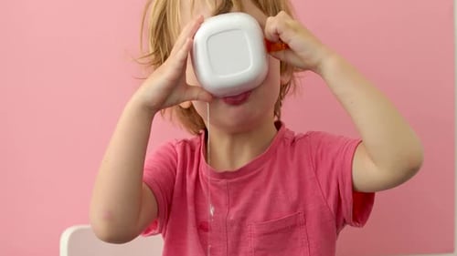 Little Blond Child Drinking Messily at Home
