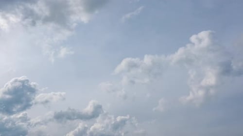 Clouds Moving Slowly Across a Blue Sky