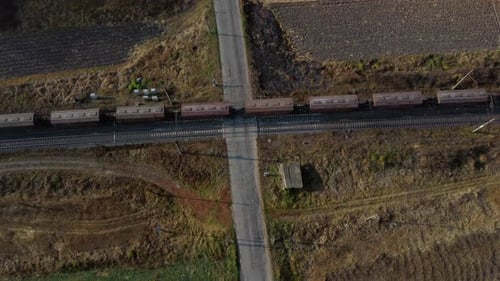 Top View Freight Train Passing Railway Crossing