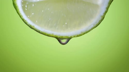 Fresh Slice Lime, a Drop of Water Falls. The Fruit Gives Off Freshness and Juice Filling