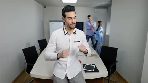 Young Adult Celebrates Achievement in Modern Office