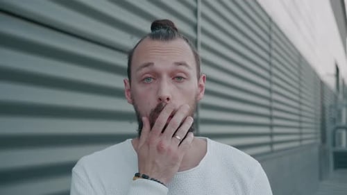 Man Reacting to Surprising News Outside