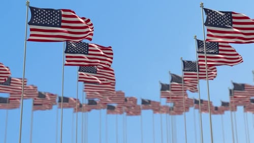 Waving United States Flags Against Blue Sky