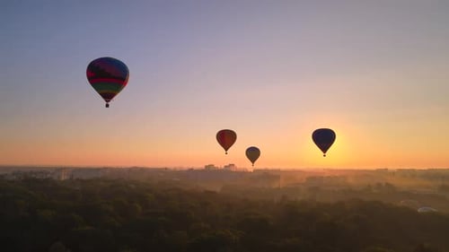Aerial Drone View of Colorful Hot Air Balloon Flying Over Green Park and River in Small European