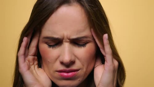 Exhausted Woman with Migraine Posing at Camera. Tired Girl Having Headache