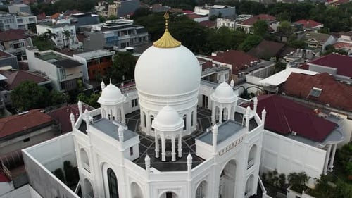 Aerial view of modern Masjid Ramlie Musofa in Jakarta Kemayoran with Jakarta cityscape