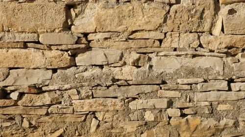 Layers of stone wall slow tilt 4K 2160p 30fps UltraHD footage - Ancient masonry construction close-u
