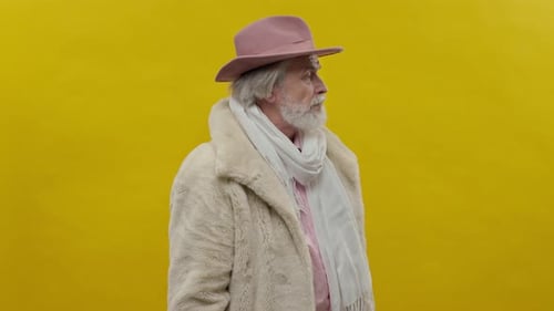 Senior Man Fashionable Posing Against Yellow Background