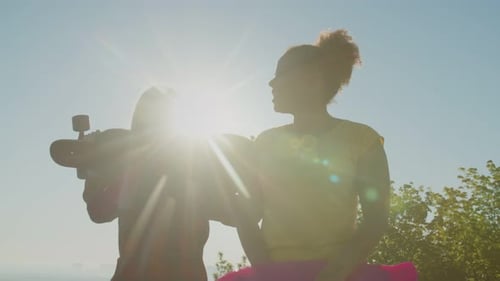 Young Women Skateboarding in City Sunlight