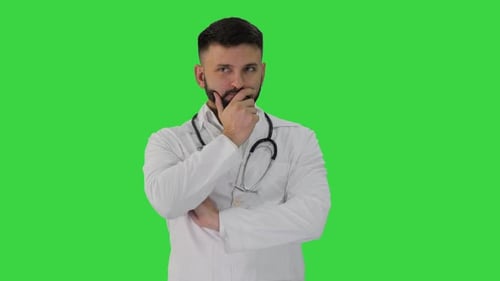 Doctor Standing and Thinking Hard on a Green Screen, Chroma Key.
