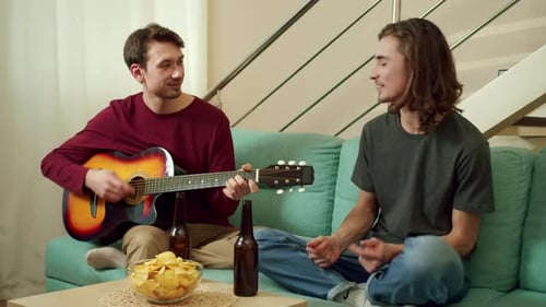 Two Friends Playing Guitar and Singing