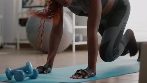 Athlete Woman with Black Skin Doing Running Plank Exercise on Yoga Map