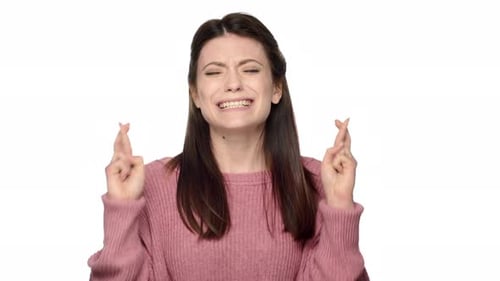 Woman With Crossed Fingers on White Background