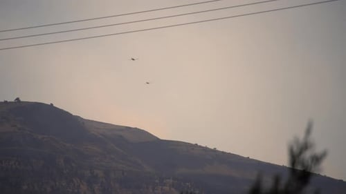 Two Planes Flying Over Mountain Landscape